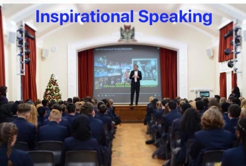 Kash speaking at a school assembly