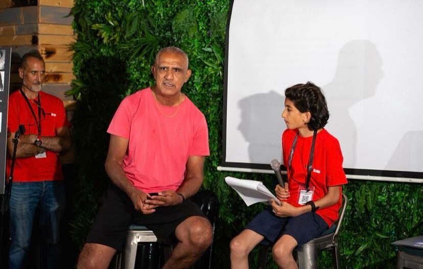 Kash interviewed by a young fan on stage